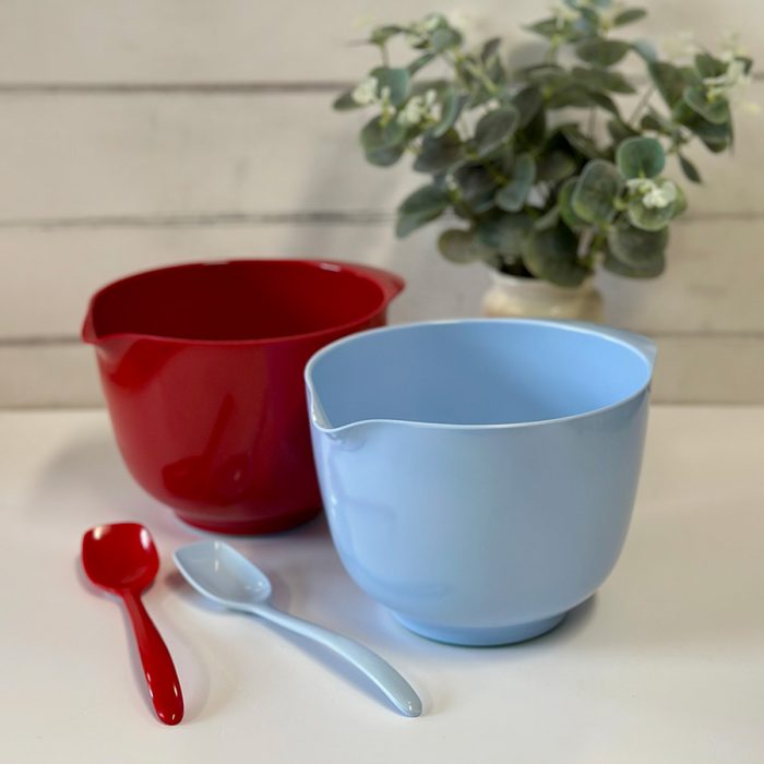 blue and red mixing bowls with small mixing spoons