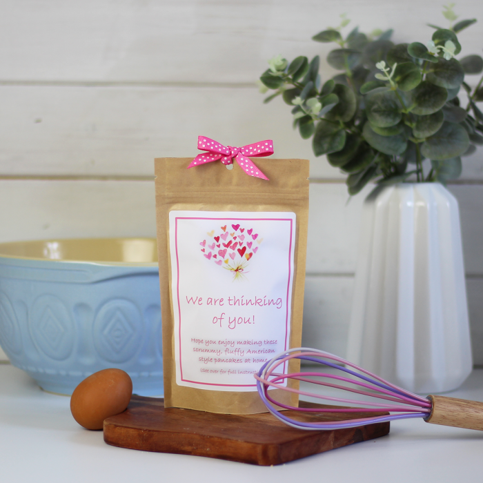 A triple chocolate pancake mix packaged in an eco-friendly kraft pouch with a heart bouquet themed label.
