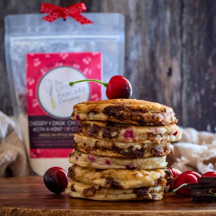 Cherry pancake stack with pancake mix in the background